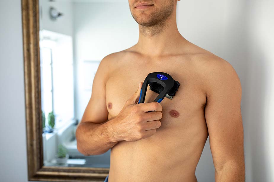 man shaving his chest with the bodblade