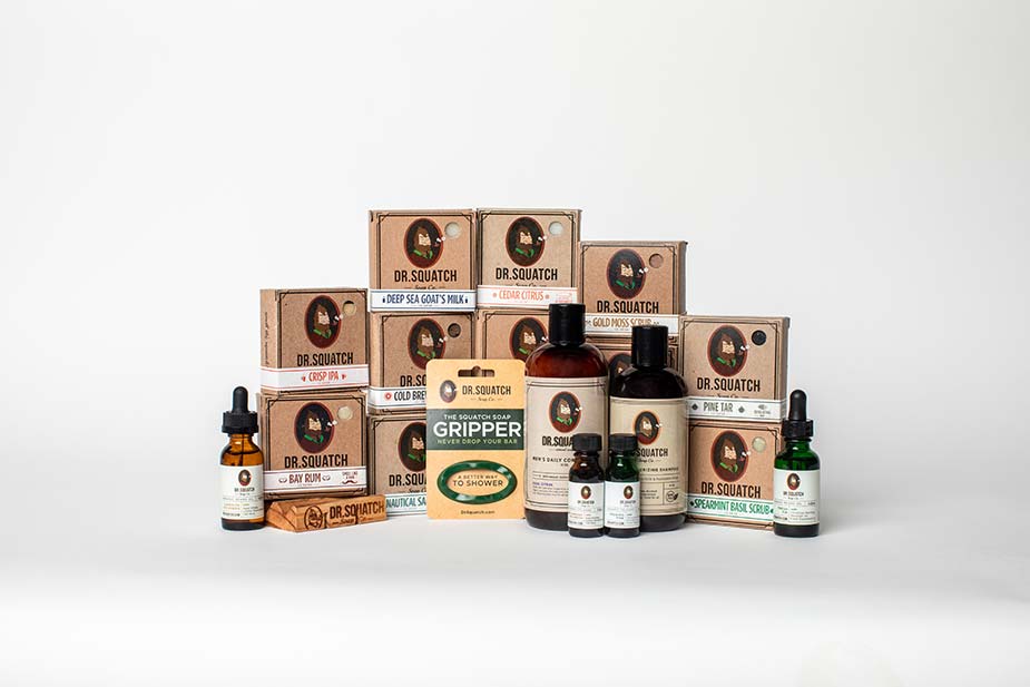 collection of various Dr. Squatch products displayed on a light gray studio background