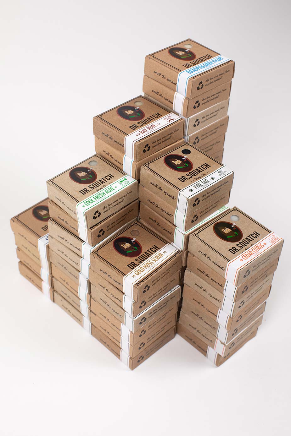 isometric view of stacks of Dr. Squatch soap bars on a light gray studio background