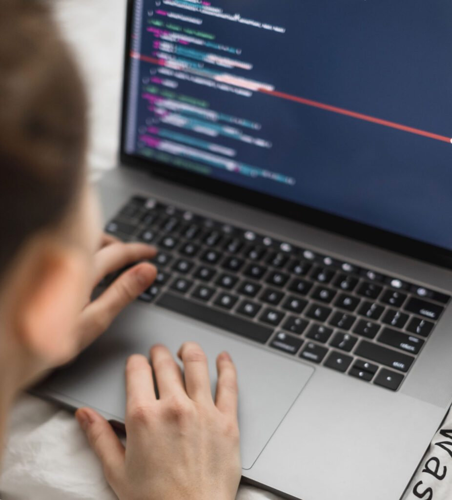 photo of man coding a website on a laptop