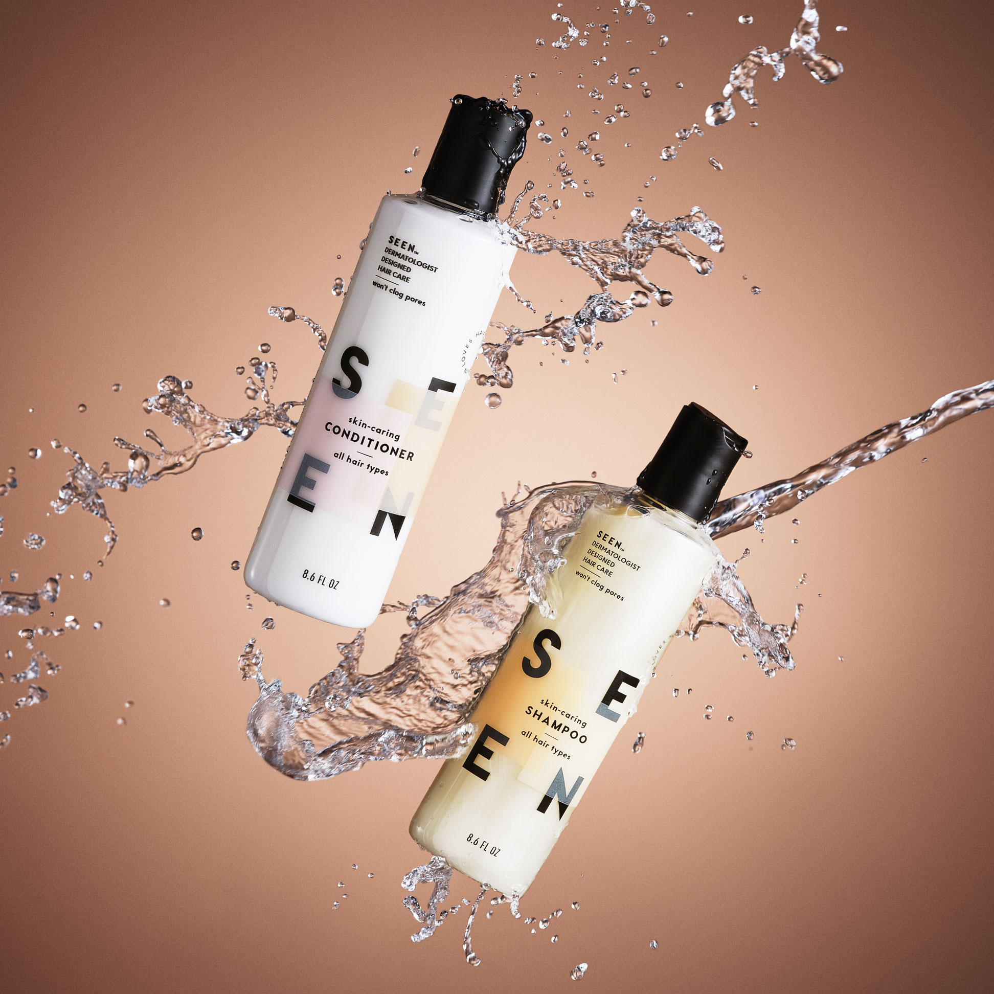 two bottles of seen haircare products floating with water splashes against a brown gradient background